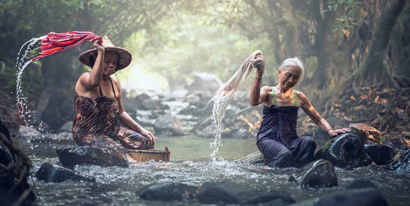 old women washing clothes in the river in Cambodia